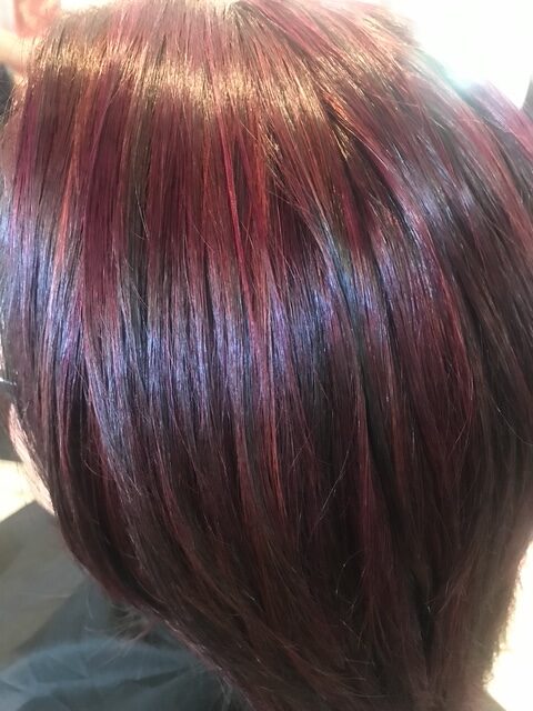 Dimensional hairstyle with soft waves styled by Elaina at salon.