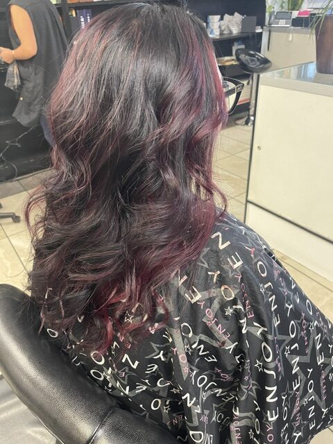 Expert hair cutting technique with stylist focusing on detail.