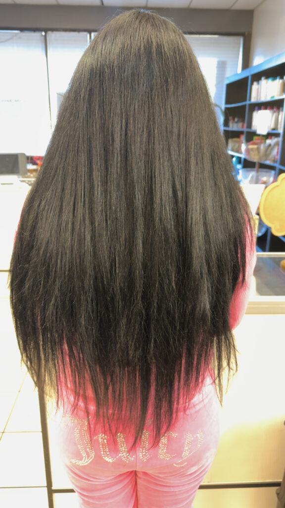 Happy client posing with fresh hair style after customized service.