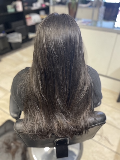 Dimensional hair color result on client capturing natural shine.