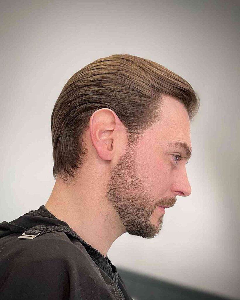 Warm medium brown hair color styled for male client at salon.